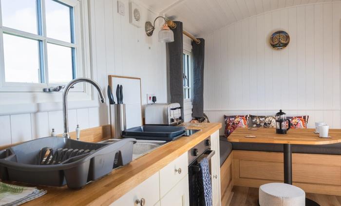 Galley kitchen and corner sofa area with fairground styling